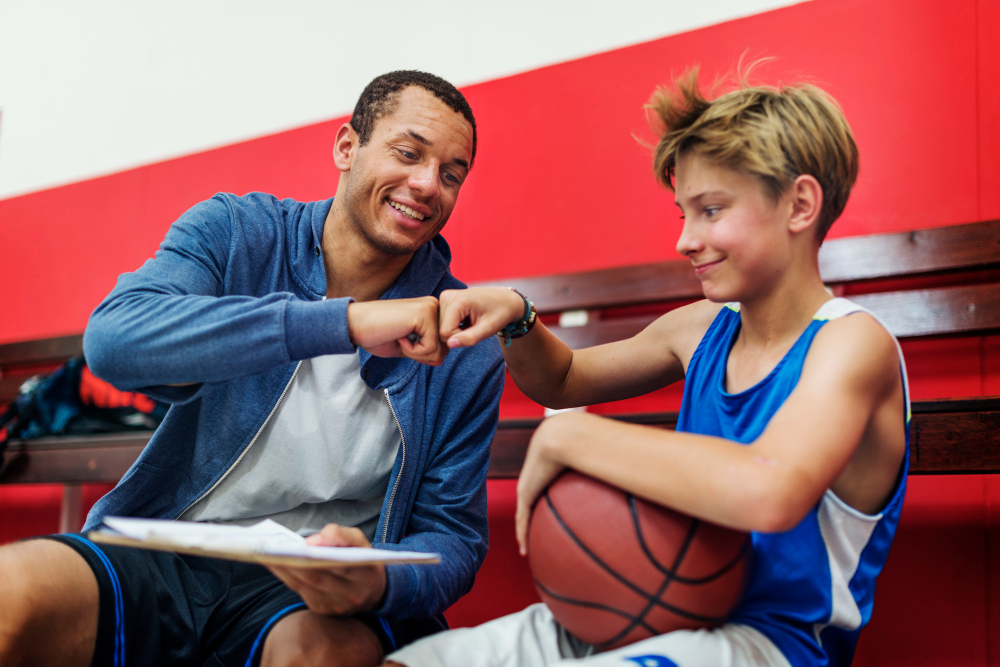 Sports coach training a student on the field